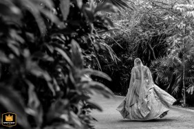 Black and white photo of the bride walking away from the party to join her family in Puerto Morelos.
